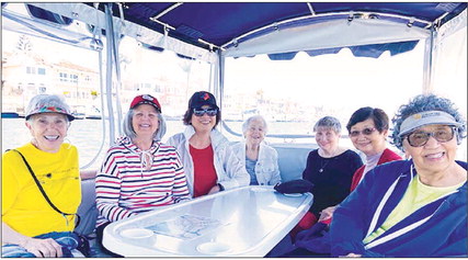 Sunshine Club members take a ride on a Duffy Boat