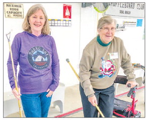 Shuffl eboard Club member plays with an assist